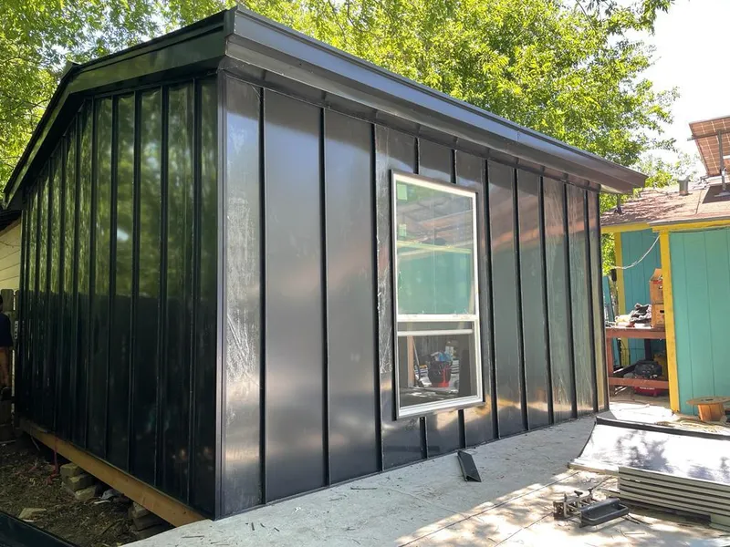 Black standing seam metal wall panels for Roof Inspection in Spring