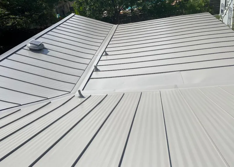 Solar attic fan installed on a metal roof for Roof Ventilation in Spring